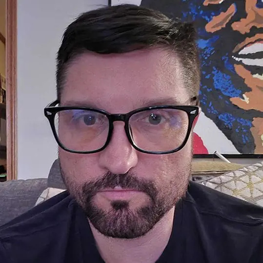 a man sitting at a desk using a laptop