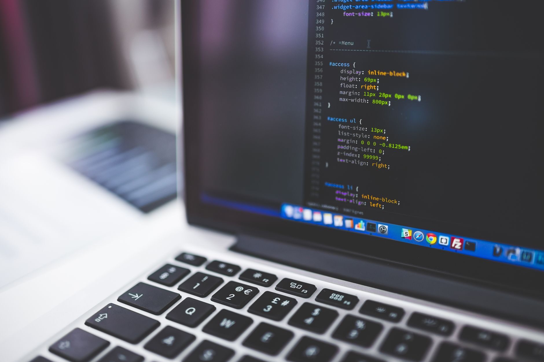 Schema markup code displayed on a laptop for a Lafayette business website